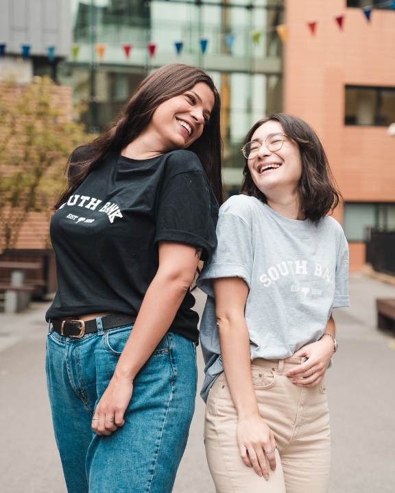 Models in South Bank SU branded T-shirts laughing