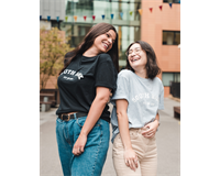 Models in South Bank SU branded T-shirts laughing