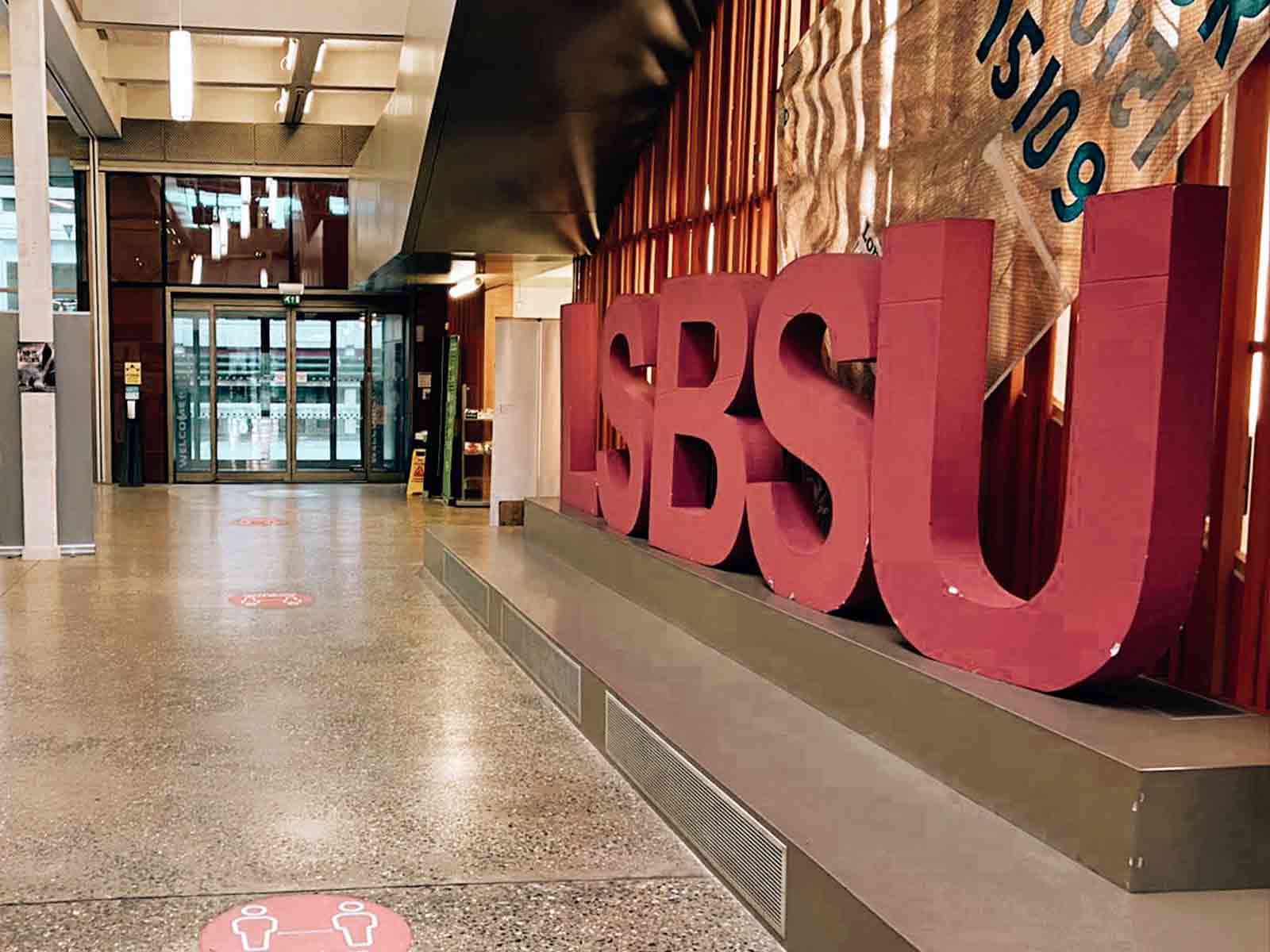 A photograph of giant letters in a campus building reading LSBSU